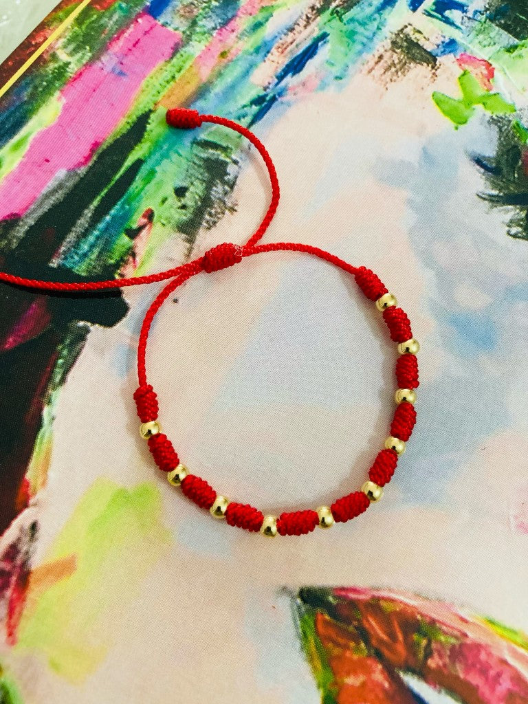 Pulsera tejida con balines en oro laminado 18k